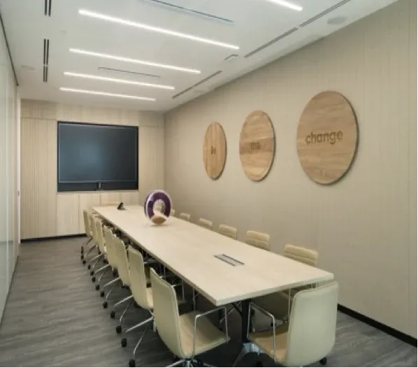 Boardroom in a Singapore headquarters with a long table and wall display, fitted out by VisionCast
